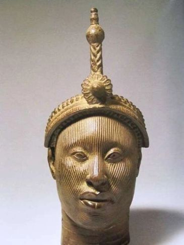 Bronze head sculpture with detailed facial features and ornate headdress.