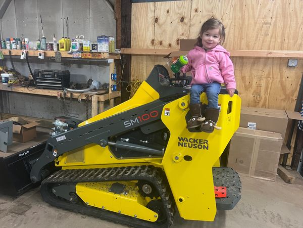 Erick's kiddo showing off their new skid steer trencher