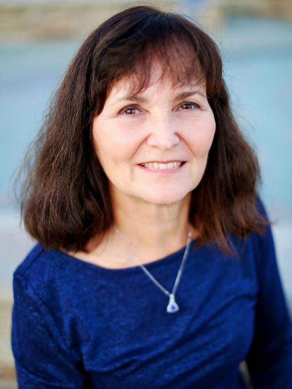 Photo of Dr. Stephens. Woman with short brown hair wearing blue top.