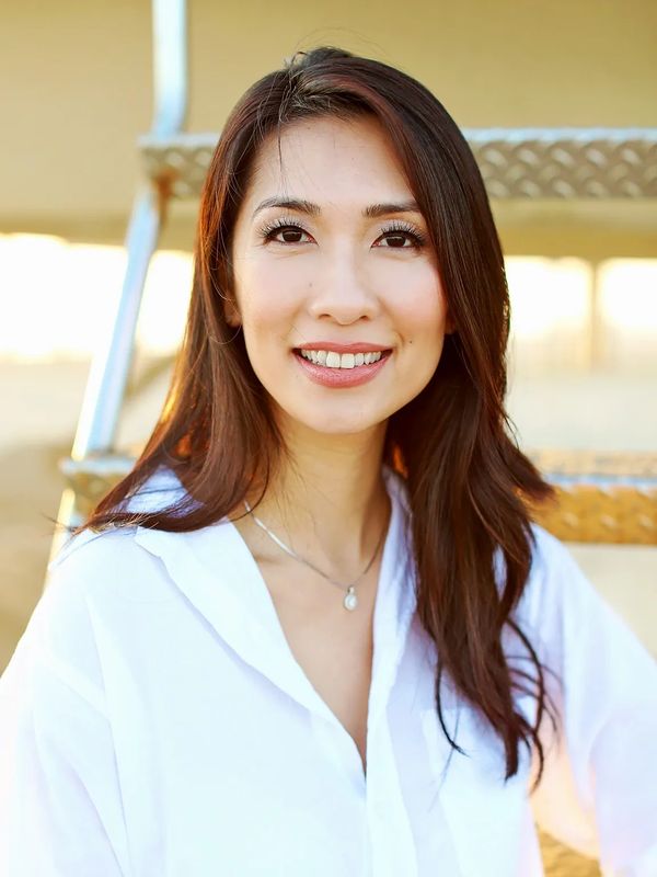 Photo of Dr. Ha. Asian woman with long hair wearing white shirt.