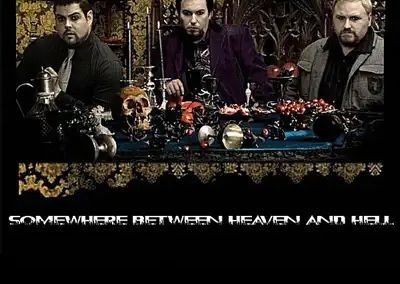 Three men around a dark, eerie table with skulls and candles, text reads 'Somewhere Between Heaven and Hell'.