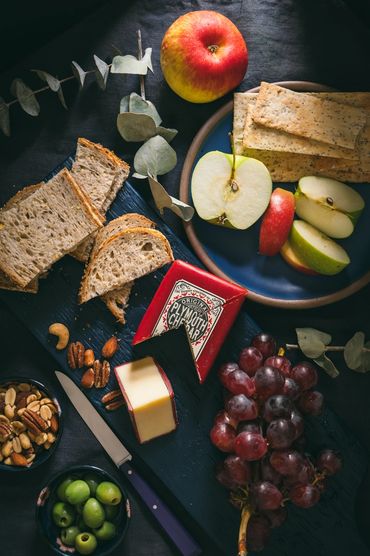 Cheese Board with Fruits, Nuts, Olives