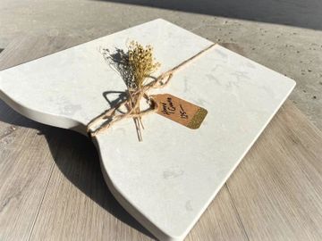 A picture of a tile being tied on with a rope