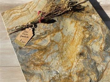 A picture of dried leaves on a tile