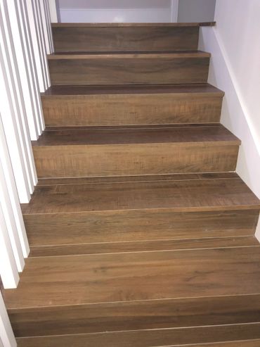 A pictures of stair case in brown color wood work