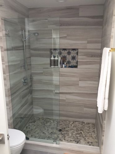 A picture of a glass door shower room in a bathroom