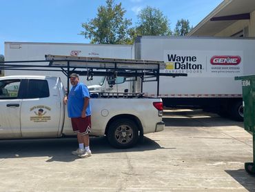 Joey’s owner beside the company work truck at Wayne Dalton in Covington, Louisiana