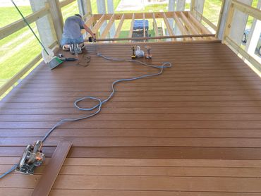 Wooden deck under construction with a circular saw and boards