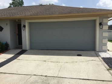 Gray double garage door installed in Kenner, Louisiana