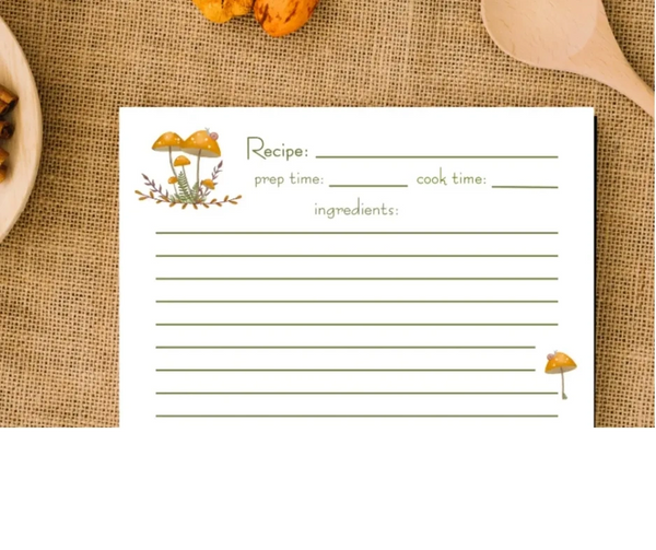 Hand-illustrated recipe cards with mushroom art on burlap background and rustic table setting