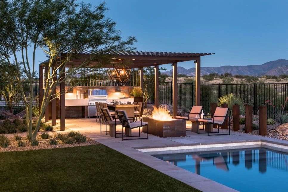 Outdoor patio with fire pit and pool at dusk.