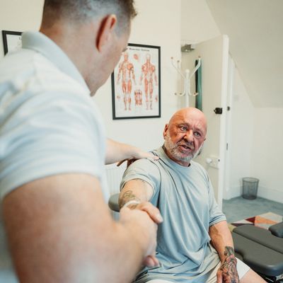 Man getting physical therapy on his shoulder.