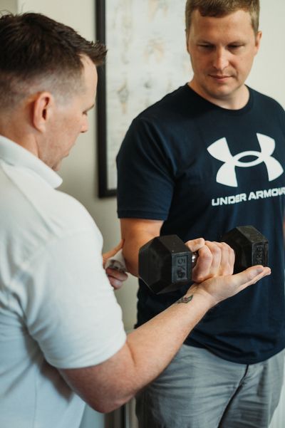 Chiropractor guiding a patient through a rehabilitation exercise at Tenby Chiropractic, Pembroke.