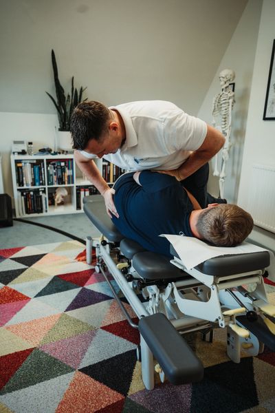 Patient receiving chiropractic treatment for back pain from disc irritation