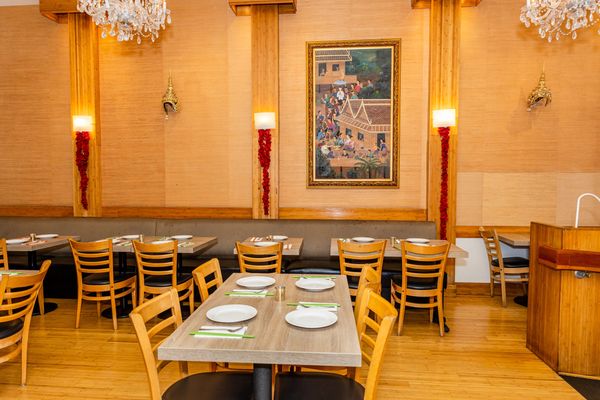 Inside view of a hotel with some tables and chairs