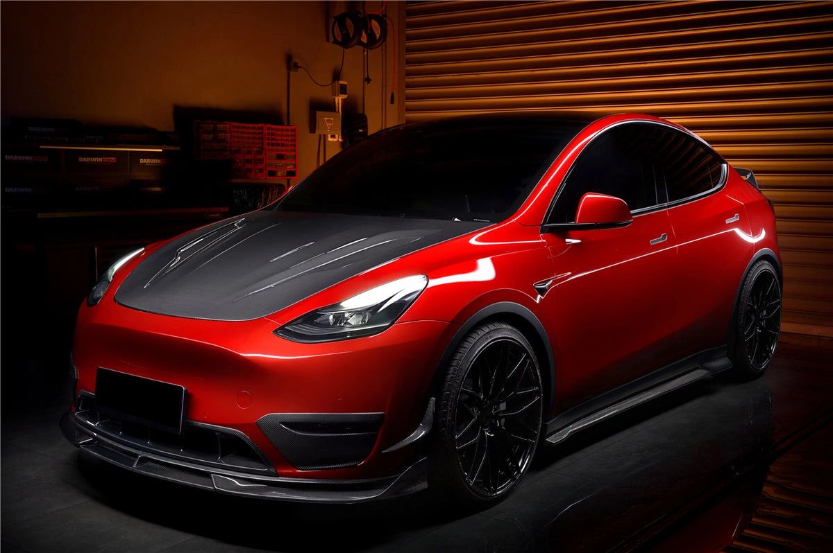 Red Tesla with windows tinting in garage.