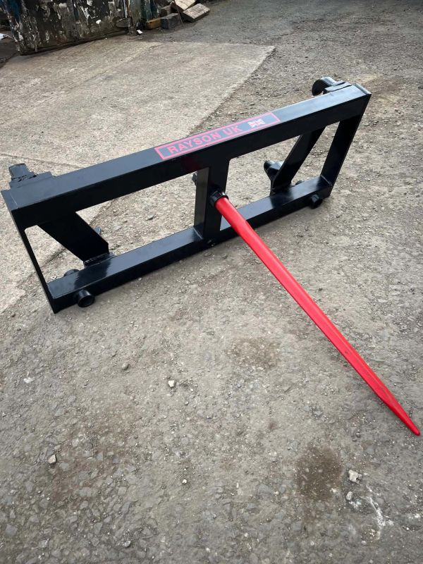 A black metal frame with a red spike on a concrete surface.