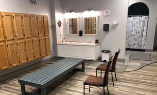 Locker room and shower area with sauna and steam room.
