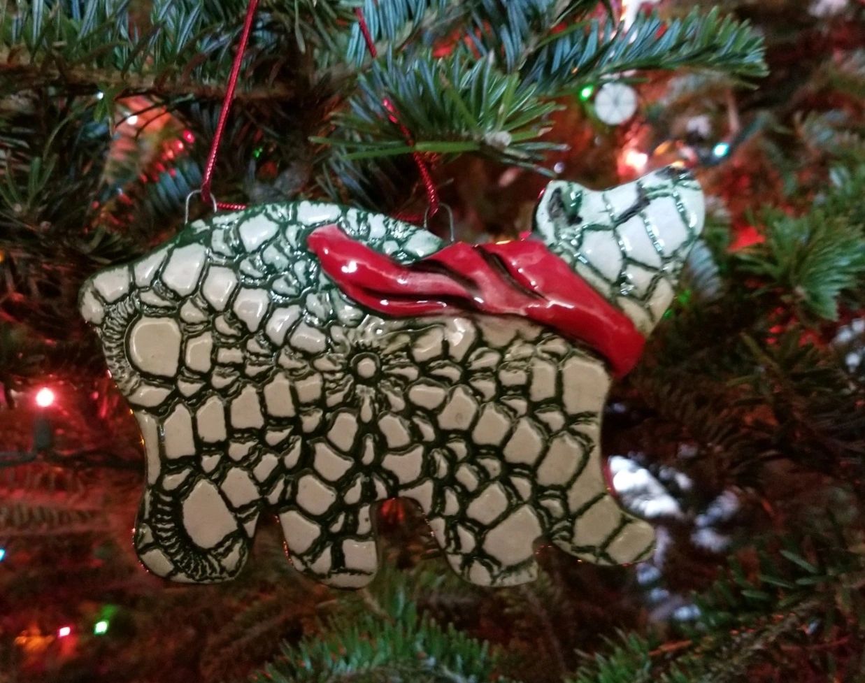 a polar bear ornament hanging on a christmas tree