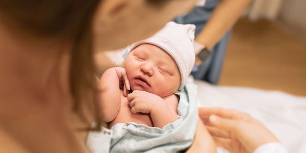Woman looking at her new born baby