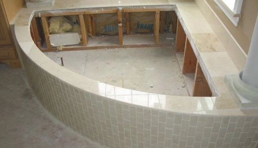 Beautiful white marble tile soaking tub deck and surround