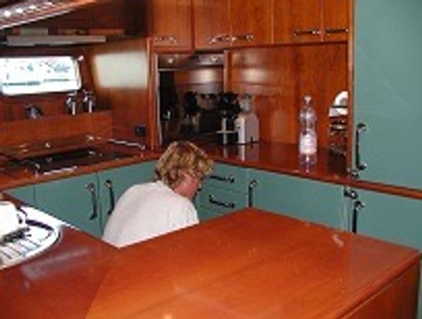 man inside boat repairing cupboards