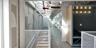 Modern hallway with glass doors and industrial design elements.