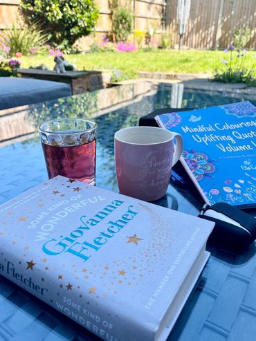 Relaxing with my book and mindful colouring book