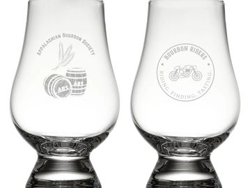 Two clear bourbon tasting glasses with engraved logos.