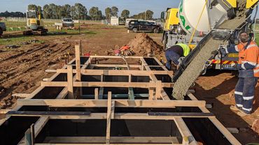 concrete pour of formed in place strip footings for a solar farm.