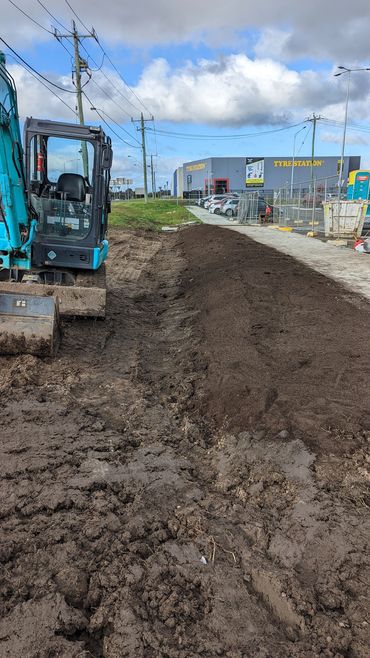 a five tonne Kobelco Excavator after completing a swale drain and top soil reinstatement.
