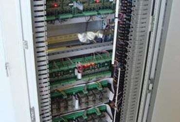 Open industrial electrical control panel.