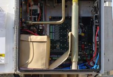Close-up of open electrical panel wiring.