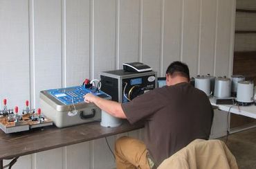 Worker operating bench testing machinery.