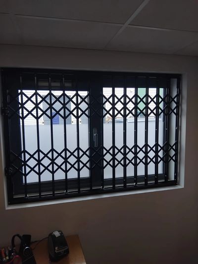 Concertina security gates London manufactured for retail, office and warehouse protection