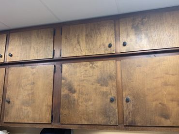 Dirty faded cabinets in a church basement.