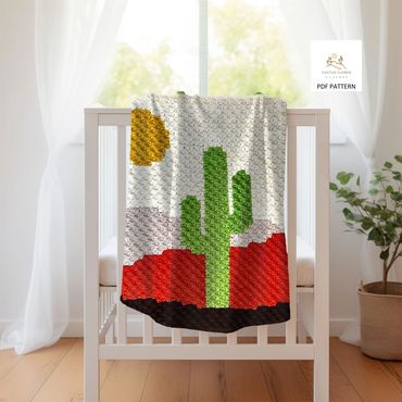 baby blanket with a saguaro and sun in a desert background, hanging on a crib