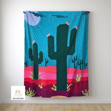 sofa throw with a bright desert colors, silver moon and multiple saguaros
