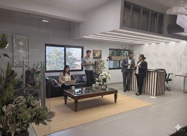 Modern office lounge with people working and conversing.