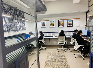 Office workers focused on their computers in a modern workspace.