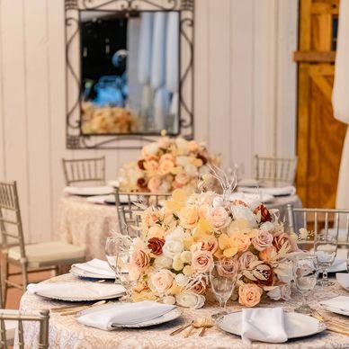 Elegant wedding tables with floral centerpieces and fine table settings.