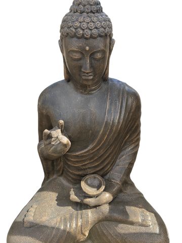 Stone Buddha statue in meditation pose with detailed curls and serene expression.