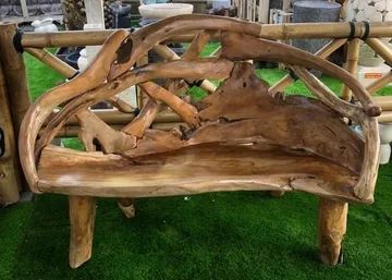 Rustic wooden bench made from natural tree branches and logs.