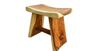 A rustic wooden stool with a curved seat and sturdy legs.