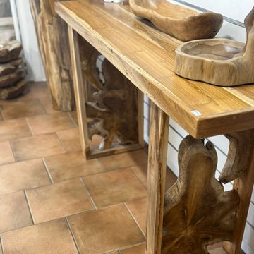 Handcrafted wooden furniture with natural wood grain details on a tiled floor.
