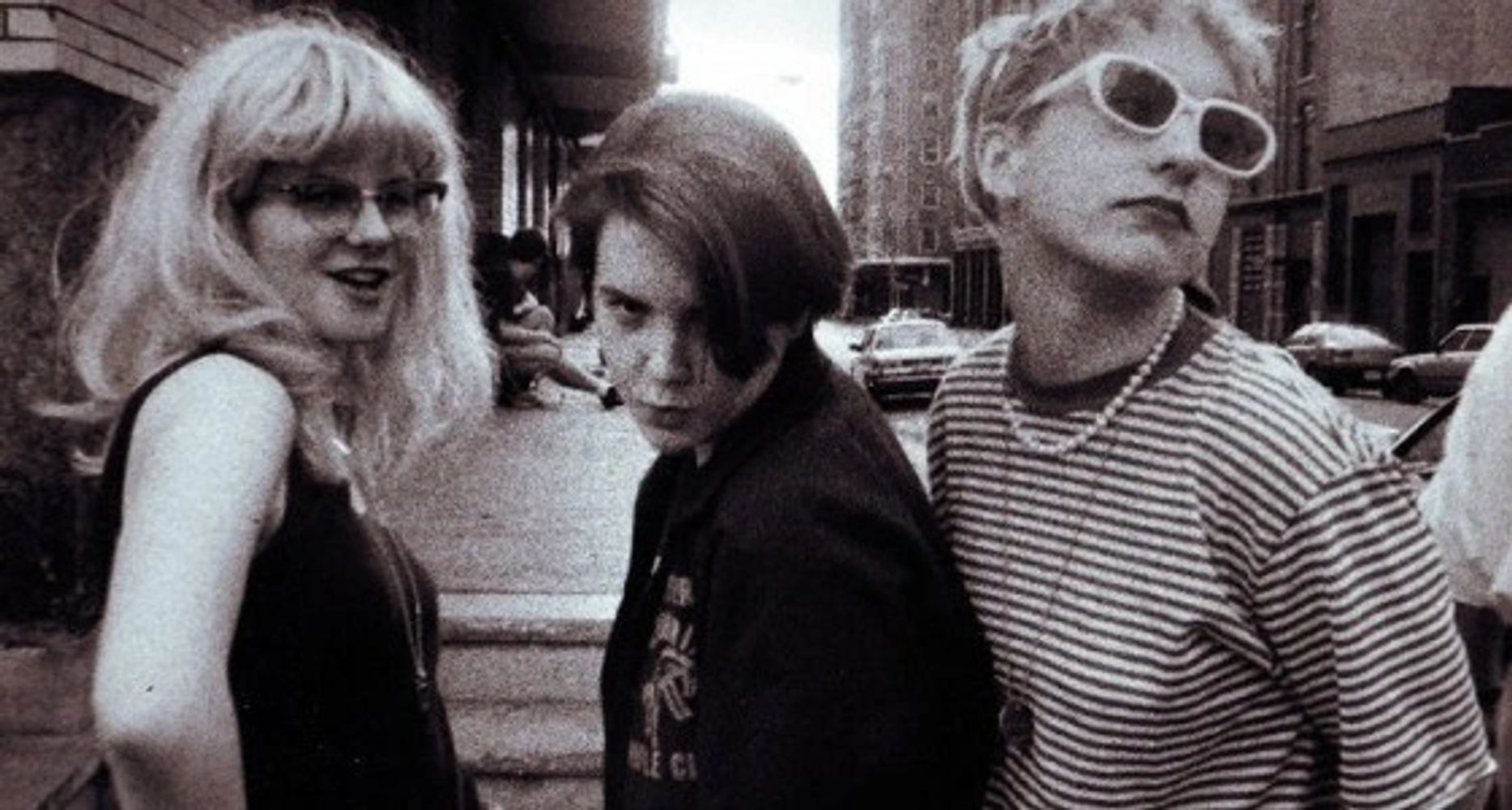 (an image of Bratmobile posing for a camera on the street)