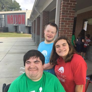 A couple friends with disabilities with one of our best volunteers