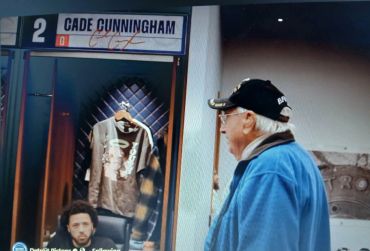 Locker area with Cade Cunningham's name and an elderly man.