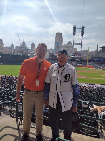 Two men at a Detroit Tigers baseball game.