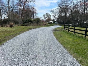 Graded and new stone spread on farm lane.